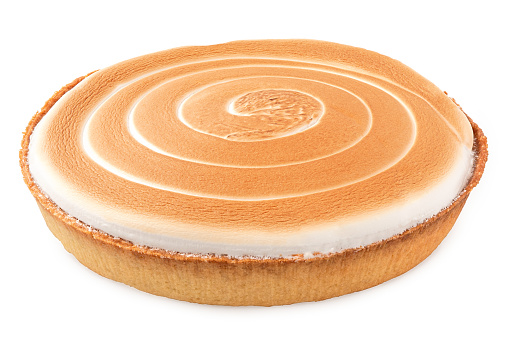 Whole lemon tart with meringue swirl topping isolated on white.