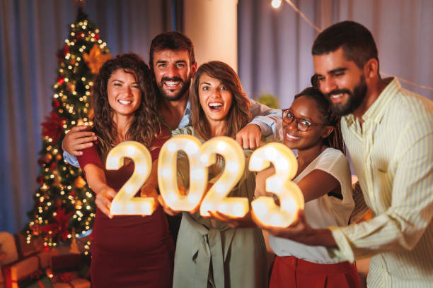 istock Friends holding illuminative numbers 2023 while celebrating New Year 1435013302