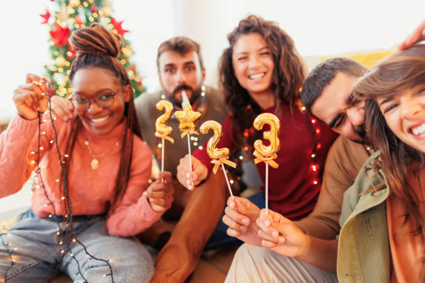 istock Friends holding little balloons shaped as numbers 2023 while getting ready for New Year celebration 1435013372
