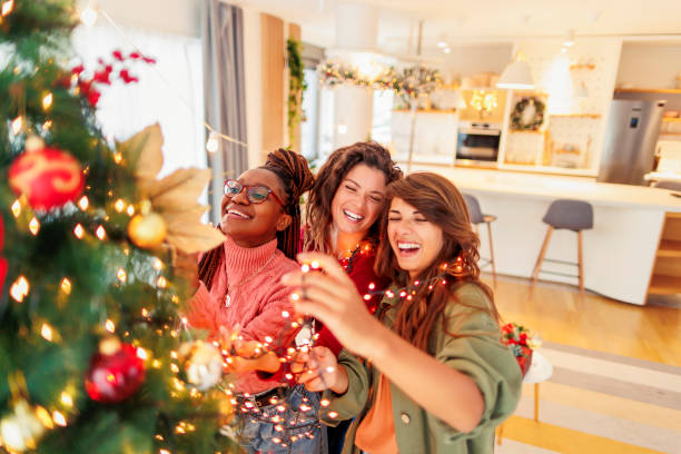Girls decorating Christmas tree