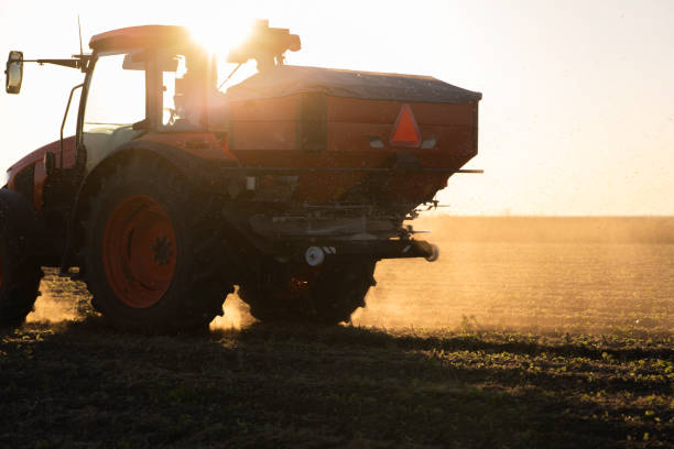istock Tractor spreading artificial fertilizers in field 1435013461