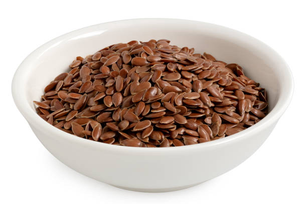 Flax seeds in a white ceramic bowl.