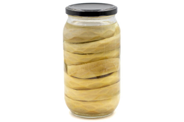 Canned artichokes in glass jar isolated on white background stock photo