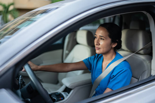 istock Female mid adult driver driving a car 1435015989