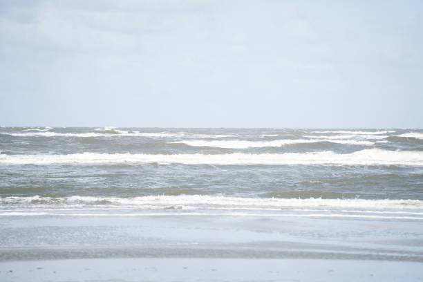istock Waves with a cloudy sky in the background. 1435016634