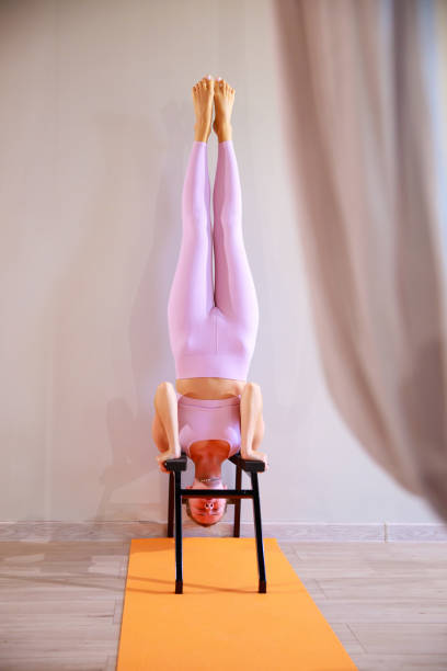 istock a young slender athletic woman makes a handstand on a steel support. 1435018128