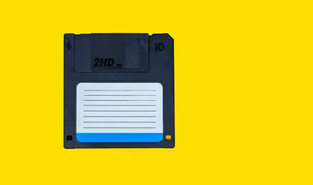 Photo of obsolete computer floppy disks on a colored background, isolated,