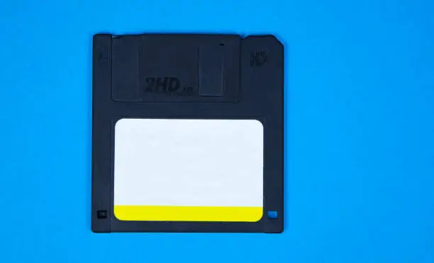 Photo of obsolete computer floppy disks on a colored background, isolated,