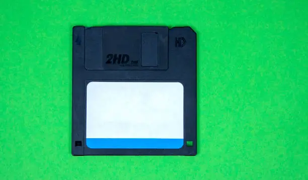 Photo of obsolete computer floppy disks on a colored background, isolated,