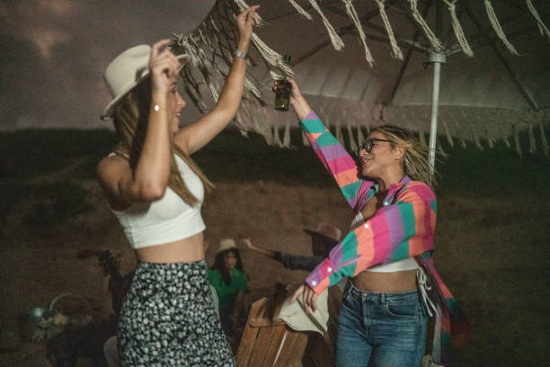 istock Female friends dancing and having fun on the beach 1435020518