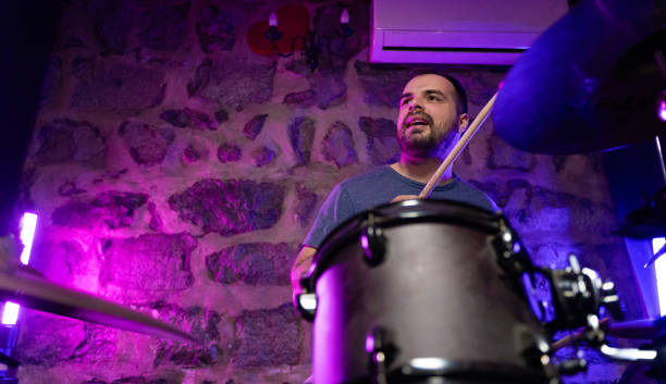 istock Young adult man playing drums 1435022251