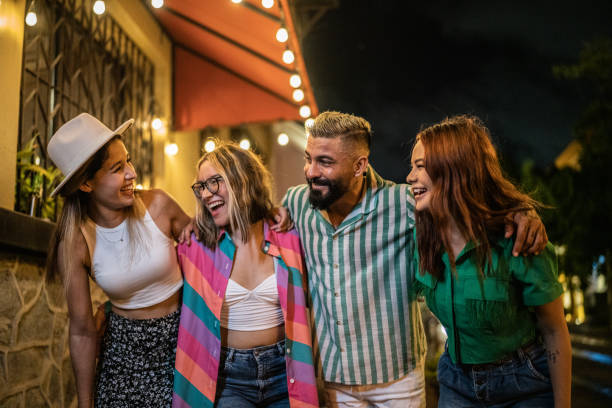 istock Friends having fun while walking on the street at night 1435025195