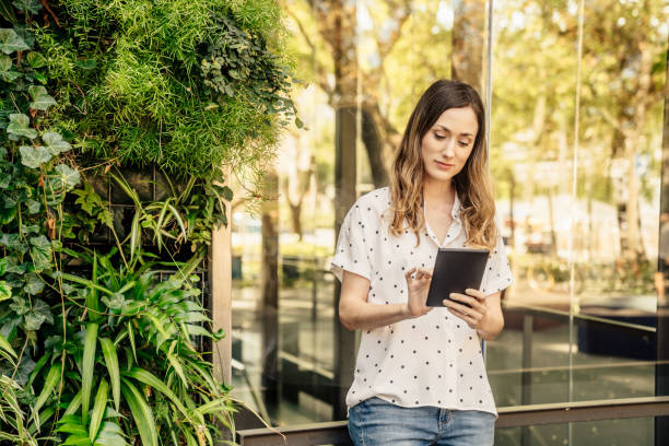 istock Woman with mobile phone smiling 1435026022