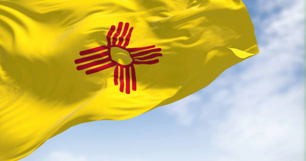 flag of new mexico state waving in the wind on a clear day - federated imagens e fotografias de stock