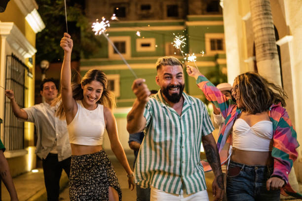 istock Friends walking while playing with sparklers on the street at night 1435026480