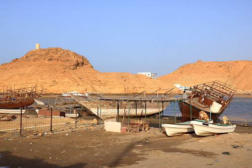 March 21 2022 - Sur in Oman: wooden dhow near a boatyard