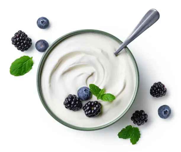 Photo of Green bowl of greek yogurt and fresh berries isolated on white background
