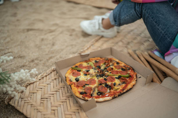 istock Pepperoni pizza on a social gathering at beach 1435027217