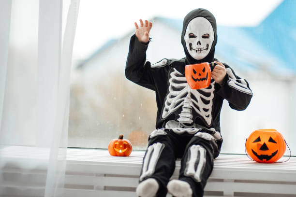 portrait of candid authentic gen z boy have fun in skeleton costume at halloween holiday - human skeleton halloween skull human bone imagens e fotografias de stock