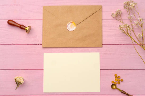istock Envelope with letter on pink wooden background top view 1435033746
