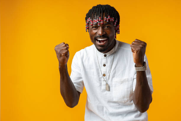 istock Young african man standing over yellow background doing winner gesture 1435034064