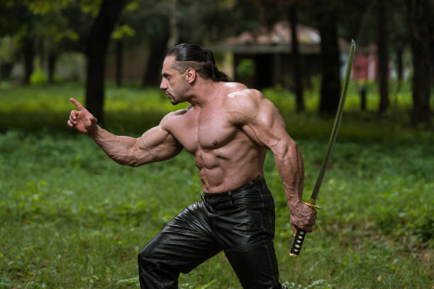 Martial artist performing a high kick with samurai sword.