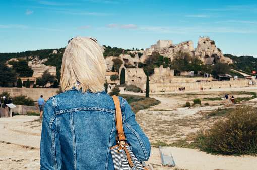 Female tourist visiting the ancient ruins at Les Baux de Provence in southern France.