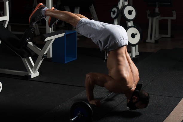 istock Man Exercising Push-Ups On Barbell In Elevation Mask 1435038123
