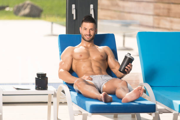 istock Man Resting on Lounger With Supplements and Shaker 1435038189