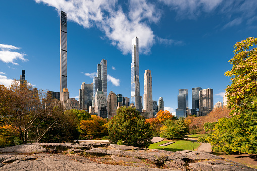 Central Park in Fall with view of the skyscrapers of Billionaires Row. Midtown Manhattan, New York City