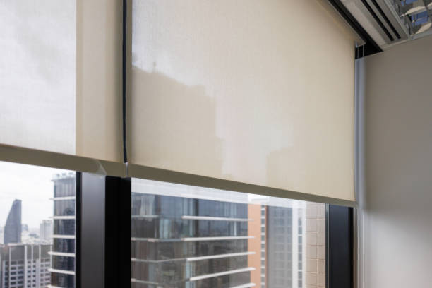 istock new white blind curtain decorate in office with tower building as background. 1435040097