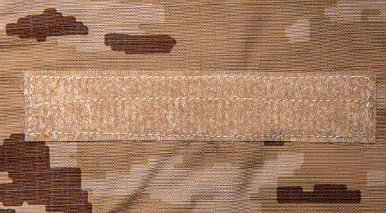 US marine desert marpat digital camouflage fabric texture background. Close-up of a fragment of a military uniform.