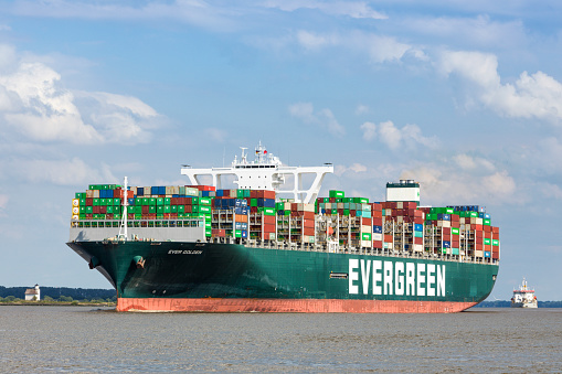 Stade, Germany – July 4, 2022:  Container ship EVER GOLDEN on Elbe river after her visit to Hamburg.