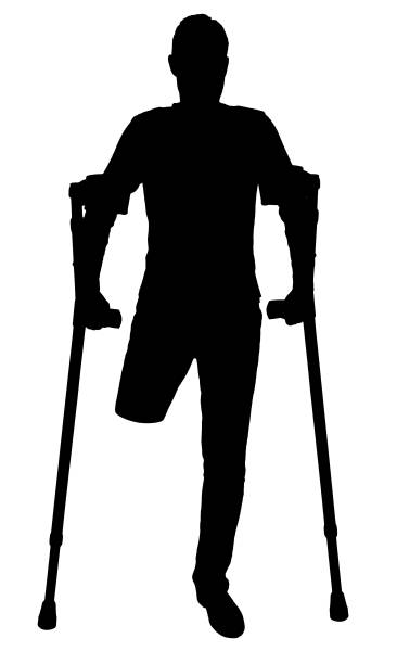 istock Vector silhouette of a man with an amputated leg standing with crutches 1435042347