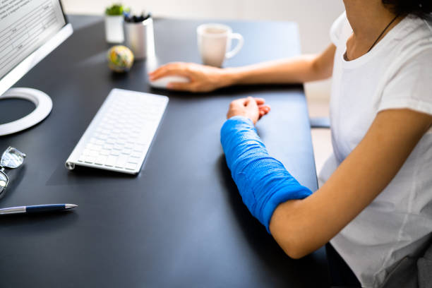 Injured Worker Compensation. Broken Arm African Woman On Computer