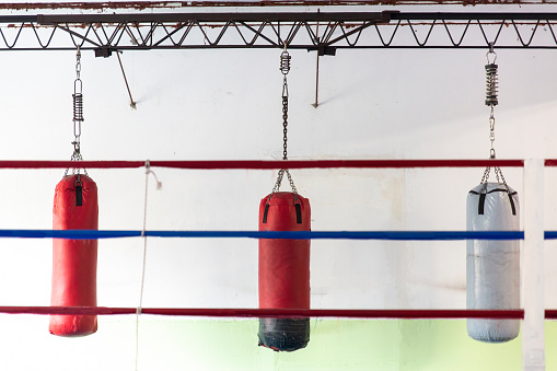 boxing gym with hanging bags, black and white sports photography
