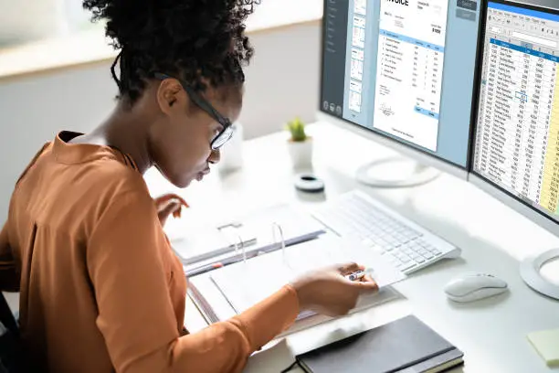 Photo of Professional African American Business Woman Doing Invoice