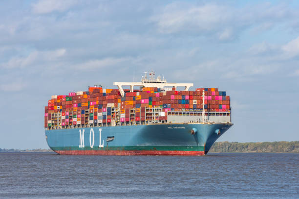 Stade, Germany – October 7, 2022: MOL TREASURE, container ship built in 2018 with a carrying capacity of 20182 TEU, length of 400 meters and width of 58.66 meters omn Elbe river heading to Hamburg