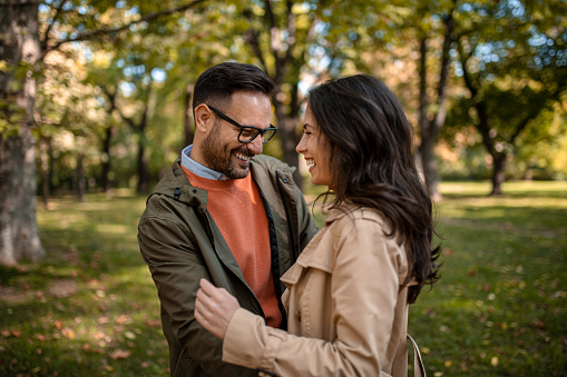 Happy couple at public park in autumn