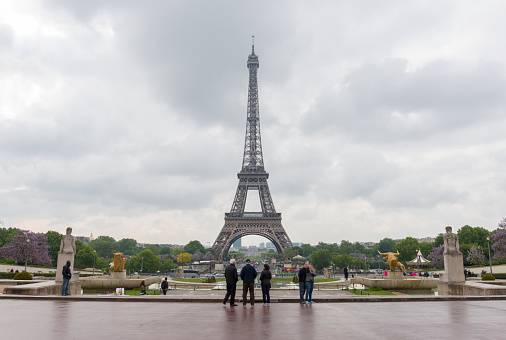 A view over the city of Paris, with the Eiffel Tower in the centre, and the modern office buildings of La Defense, the city's financial district, in the background.