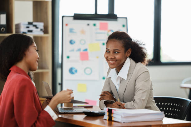 istock two women discussing business plans in the office 1435045539
