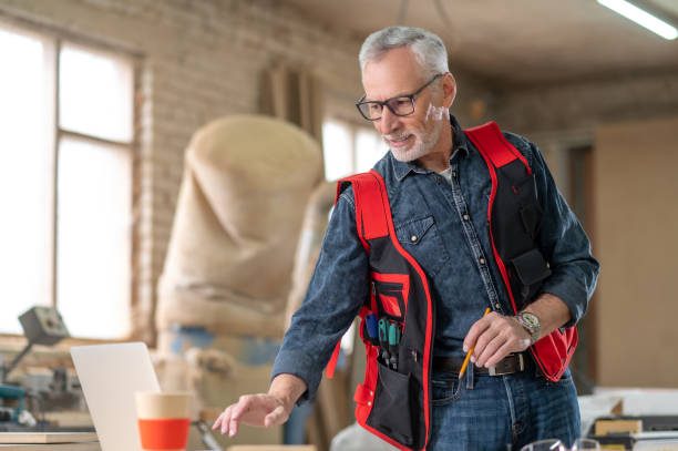 istock Mature gray-haired man in a carpentry workshop 1435046841