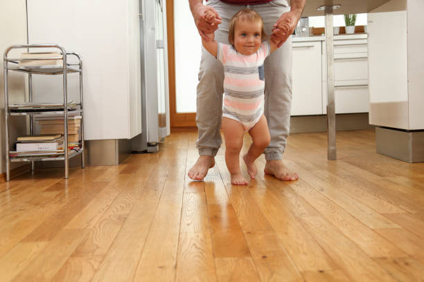 istock Father teaching his boy to walk 1435047062