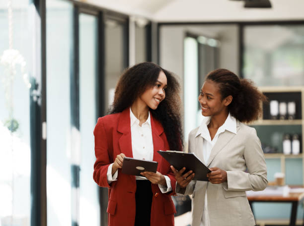 istock two women discussing business plans in the office 1435047409