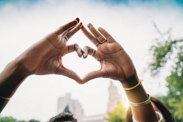 Conceptual shot of hands making heart shapes with fingers stock photo