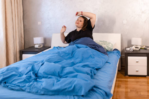 istock A woman in pajamas stretching 1435050071