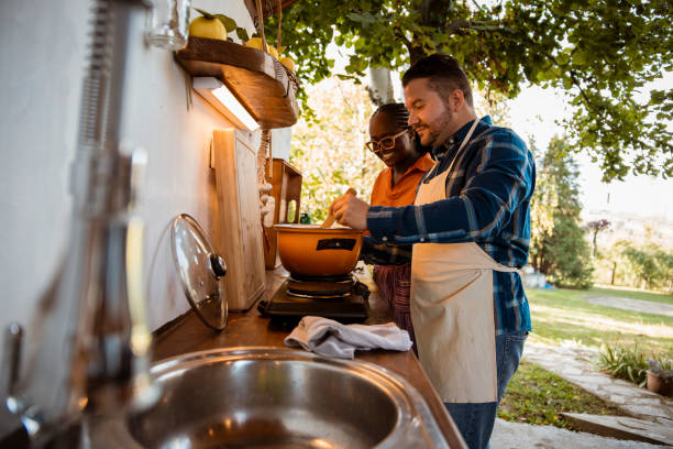 istock Happy young mixed race couple preparing a meal together 1435051201