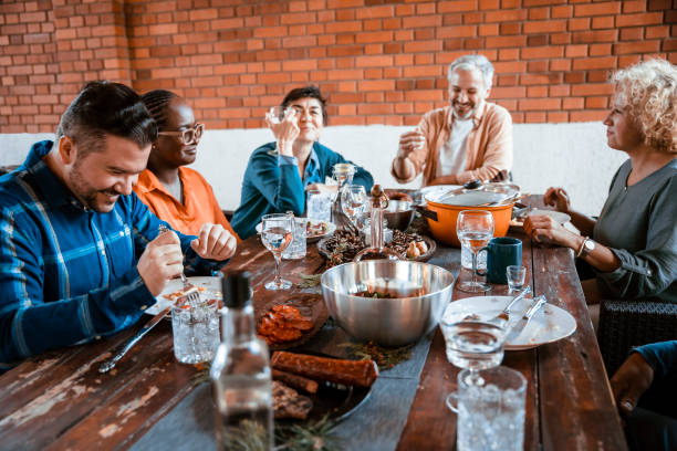 Multiracial happy Family around dining table with festive food serving for special Holiday event. Eating Together for Holidays