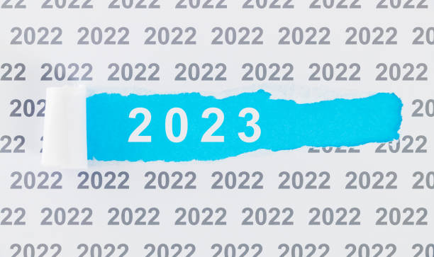 istock Torn paper with numbers year 2022 replaced by 2023 1435051278