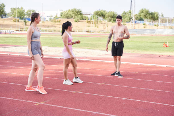 istock three people standing on the athletic track 1435051542